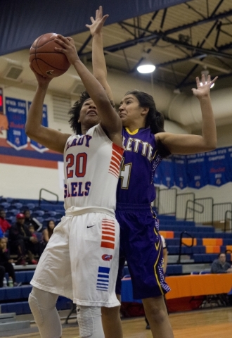 Bishop Gorman‘s Skylar Jackson (20) takes the ball to the basket as Kalina Smith (4) o ...