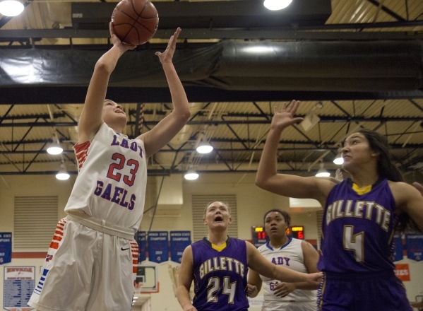 Bishop Gorman‘s Megan Jacobs (23) takes the ball to the basket during their game again ...
