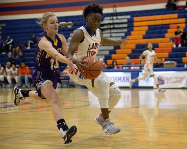 Bishop Gorman‘s Quinece Hatcher (00) tries to knock the ball away from Shyann Russell ...