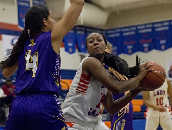 Bishop Gorman‘s Madison Washington (15) tries to keep the ball away from Kalina Smith ...