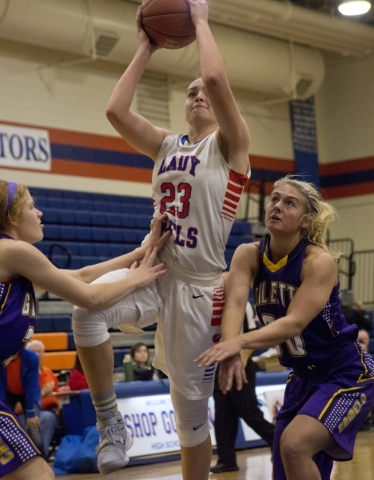Bishop Gorman‘s Megan Jacobs (23) takes the ball to basket net during their game again ...