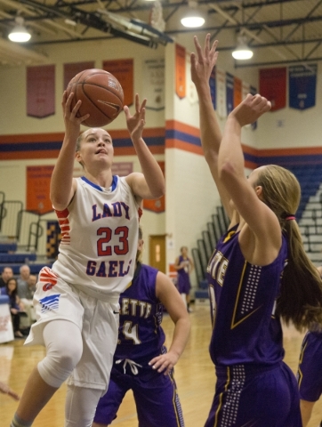 Bishop Gorman‘s Megan Jacobs (23) takes the ball to the net during their game against ...
