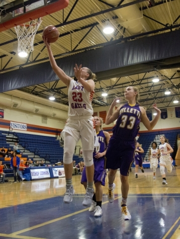 Bishop Gorman‘s Megan Jacobs (23) takes the ball to the basket during their game again ...