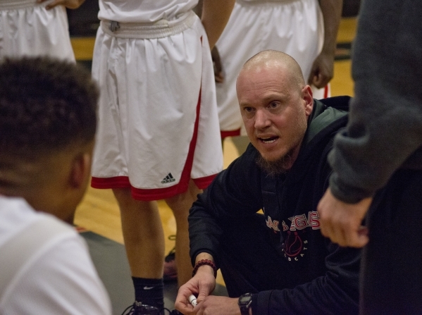 Las Vegas High School head coach Jason Wilson speaks with his team during their game against ...