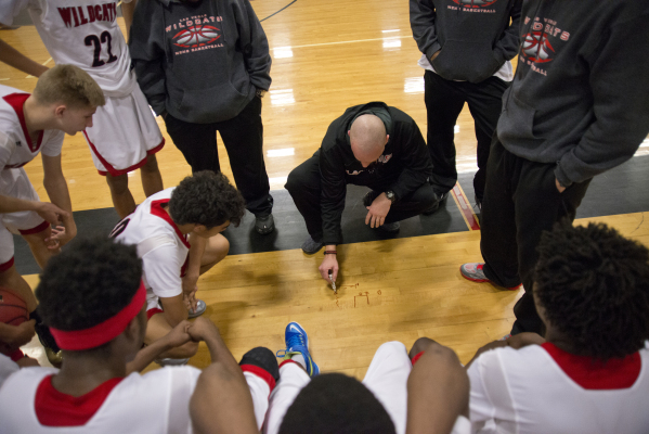 Las Vegas High School head coach Jason Wilson works out a play on the court with a dry erase ...