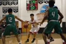 Las Vegas‘ Donovan Joyner (12) works the ball up the court during their game against ...