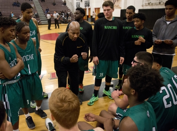 Rancho High School head coach Ronald Childress speaks with his team during their game agains ...