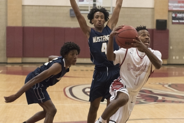 Leslie Long (1) of Desert Oasis prepares to shoot against Shadow Ridge‘s Kevin Branch ...