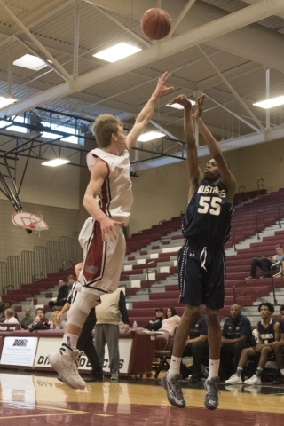 Shadow Ridge‘s Obi Okafor (55) shoots against Jacob Heese (32) of Desert Oasis during ...