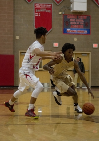 Shadow Ridge‘s Jerell Springer (0) drives against Arbor View‘s Rashaad Thoma ...