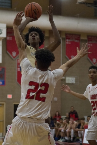 Shadow Ridge‘s Jerell Springer (0) shoots over Arbor View‘s Rashaad Thomas ( ...