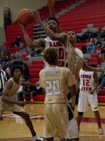 Arbor View‘s Sevonyae Smith (30) shoots over Shadow Ridge‘s Isaiah Williams (2 ...