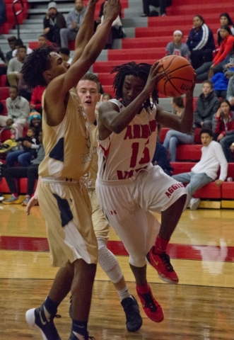 Arbor View‘s Cameron Trailer (15) works the ball around Shadow Ridge‘s Kevin B ...