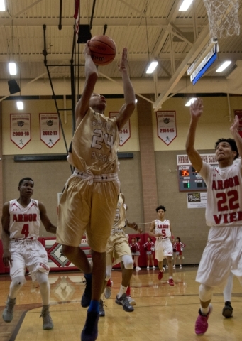 Shadow Ridge‘s Nick Blake (24) takes the ball to the net during their game at Arbor ...