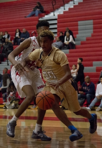 Shadow Ridge‘s Isaiah Williams (20) works the ball around Arbor View‘­s Lucas L ...