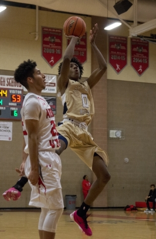 Shadow Ridge‘s Jerell Springer (0) shoots as Arbor View‘s Rashaad Thomas (22 ...