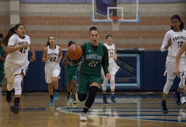 Rancho‘s Tatianna Lee (21) takes the ball up the court during their game at Foothill H ...