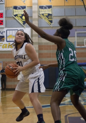 FoothillÃ­s Bri Rosales (31) looks to take a shot at the basket as Rancho‘s Ashlynn ...