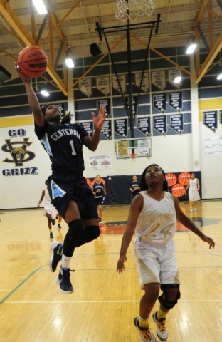 Centennial guard Pam Wilmore scores on a fast break layup in front of Spring Valley guard Ka ...