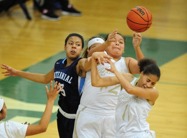 Spring Valley guard Myra Tadytin, middle, Spring Valley guard Kayla Harris (11) and Centenni ...