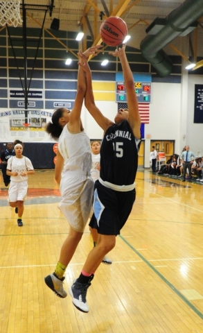 Centennial guard Samantha Thomas (25) goes up for a shot against Spring Valley guard Kayla H ...