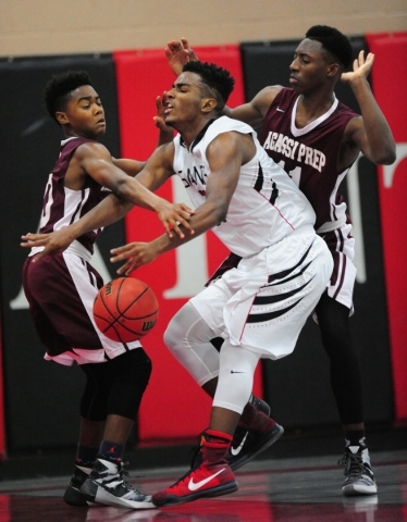 Agassi Prep guard Akeemis Williams, left, pokes the ball away from Mountain View Christian S ...