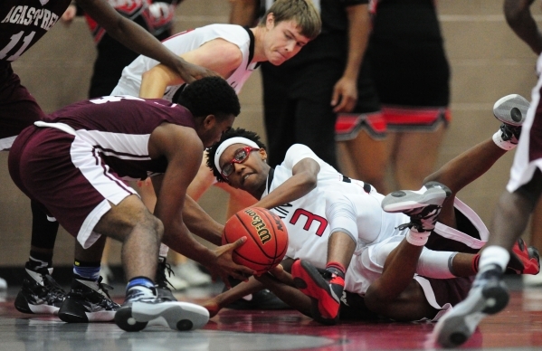 Agassi Prep forward Daniel Plummer, left, fights for a loose ball with Mountain View Christi ...