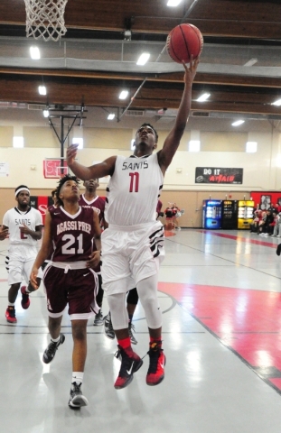 Mountain View Christian School guard Tevin Gray (11) goes up for a shot in front of Agassi P ...