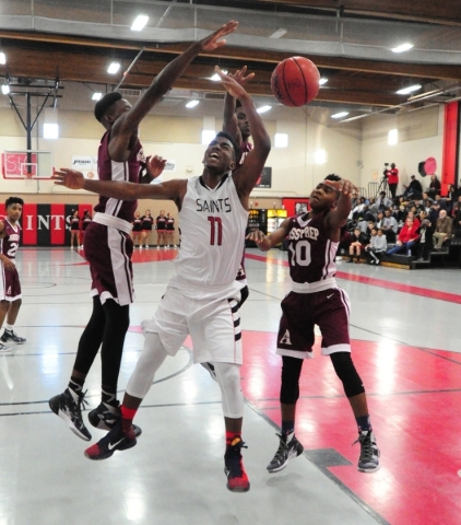 Agassi Prep guard Dion Binion, behind, blocks a shot from Mountain View Christian School gua ...