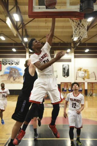 Las Vegas‘ Marquise Raybon (34) goes up for a lay-up against Green Valley defenders du ...