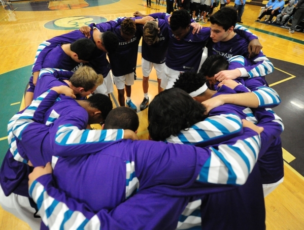 Silverado players huddle before the start of their prep basketball game against Canyon Sprin ...