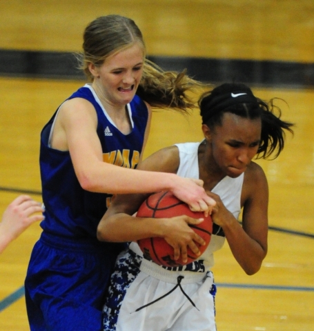 Moapa Valley guard Kinlee Marshall, left, and Desert Pines guard Chrystian Myles fight for c ...