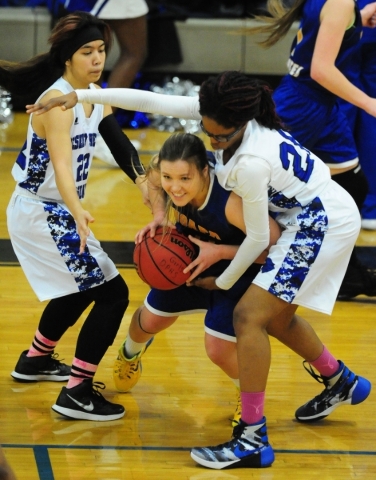 Desert Pines center Adrianne Jackson, right, attempts to steal the ball from Moapa Valley fo ...