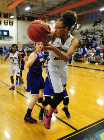 Desert Pines center Brianna Fitzgerald is able to save the ball from going out of bounds whi ...