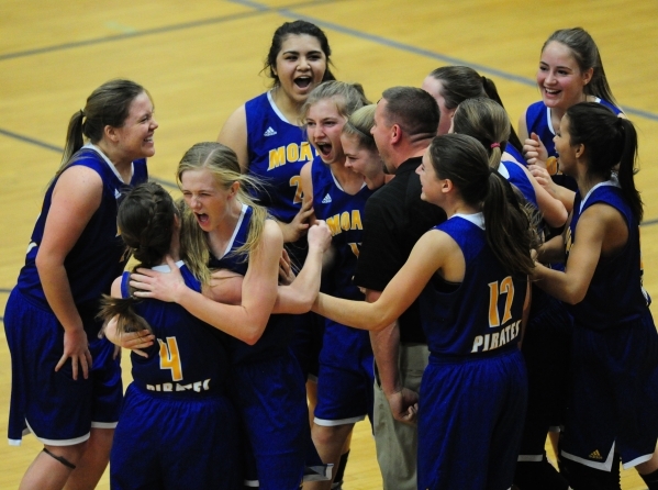 Moapa Valley players celebrate their come from behind victory over Desert Pines during their ...
