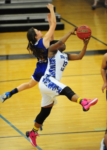 Desert Pines forward See‘Airrah Evans-Collins, right, and Moapa Valley guard Madison B ...