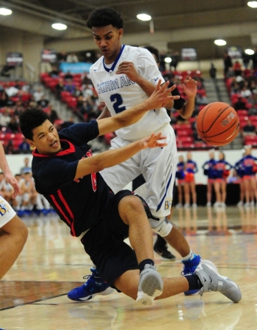 Findlay Prep guard Skylar Mays (4) passes while falling in front of Bishop Gorman guard Jama ...