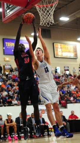 Findlay Prep guard Lamine Diane (24) grabs a defensive rebound against Bishop Gorman forward ...