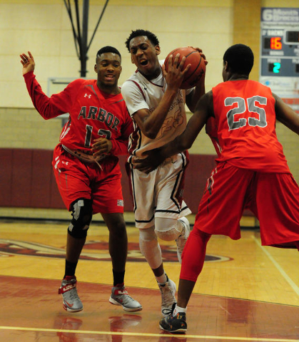 Desert Oasis forward Drevin Cannon, center is fouled by Arbor View guard Jarrod Burks (25) w ...