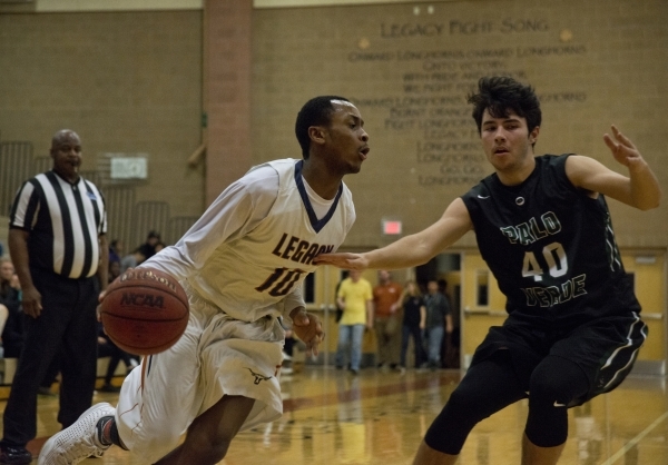 Legacyës Edward Vaughns (10) works the ball toward the basket as Palo Verde‘s Doru ...