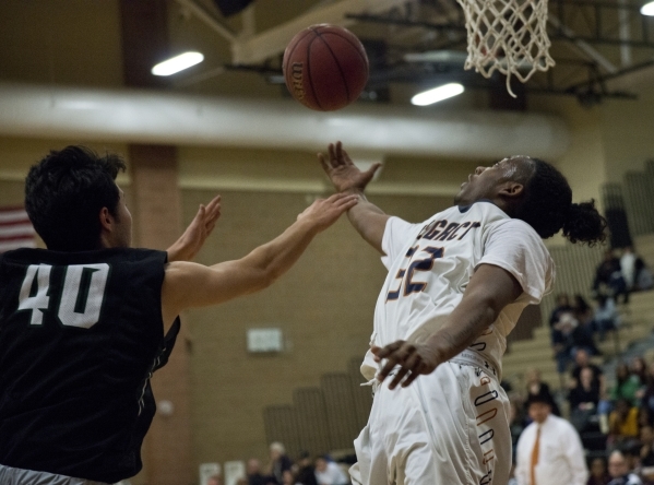Legacyës Kameron Delgadillo attempts a shot at the basket as Palo Verde‘s Doru Simi ...