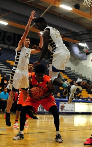 Sierra Vista forward Lerone Gibson (22) fouls Chaparral forward Ronnie Hicks (21) while Sier ...
