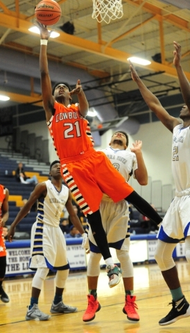 Sierra Vista forward Chris McCoy, behind, fouls Chaparral forward Ronnie Hicks (21) in the t ...