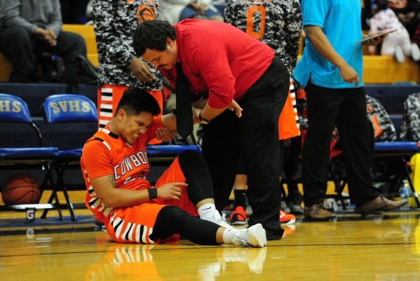 Chaparral guard Robin Rosales lies injured on the floor in the third quarter of their prep b ...