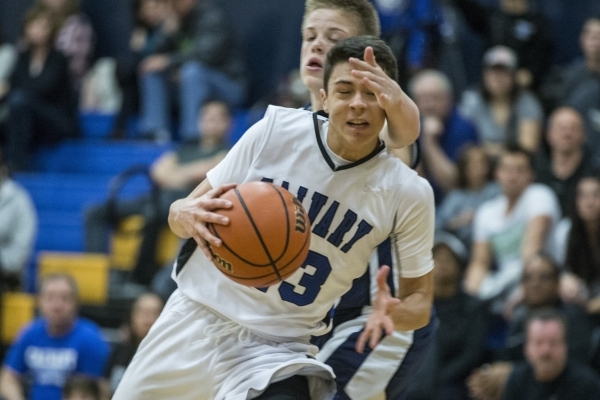 Calvary Chapel‘s Cameron Varela (23) takes a hit to the head as he makes his way to th ...