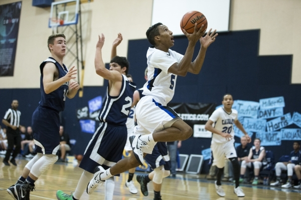 Calvary Chapel‘s Quentin Hank (5) goes up for a shot in the boy‘s basketball gam ...