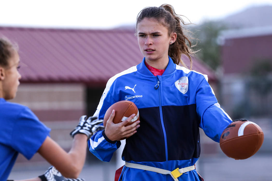 Coronado quarterback Caitlin Shannon, a 17-year-old junior, right, hands the ball off to tea ...
