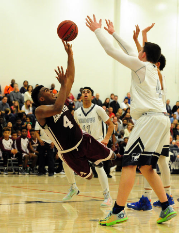 Agassi Prep forward Daniel Plummer (4) attempts a shot while falling down after he was foule ...
