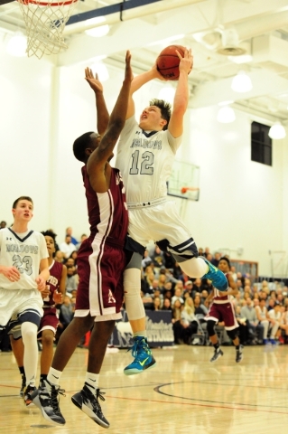 The Meadows guard Ethan Fridman (12) goes up for a shot against Agassi Prep guard Stephan La ...
