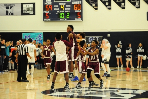Agassi Prep players celebrate their 60-59 victory over The Meadows during their prep basketb ...